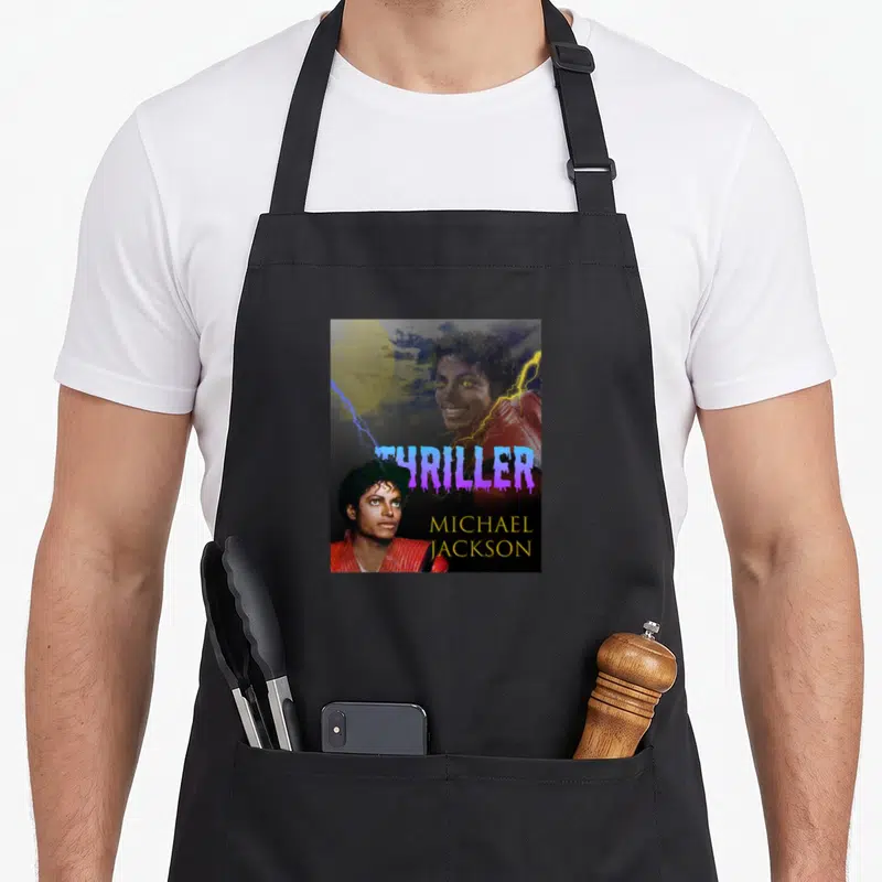 Vintage thriller michaels apron - Michael Jackson Thriller poster with purple dripping text, yellow moon, and lightning — shown on a black cotton canvas apron against a white background