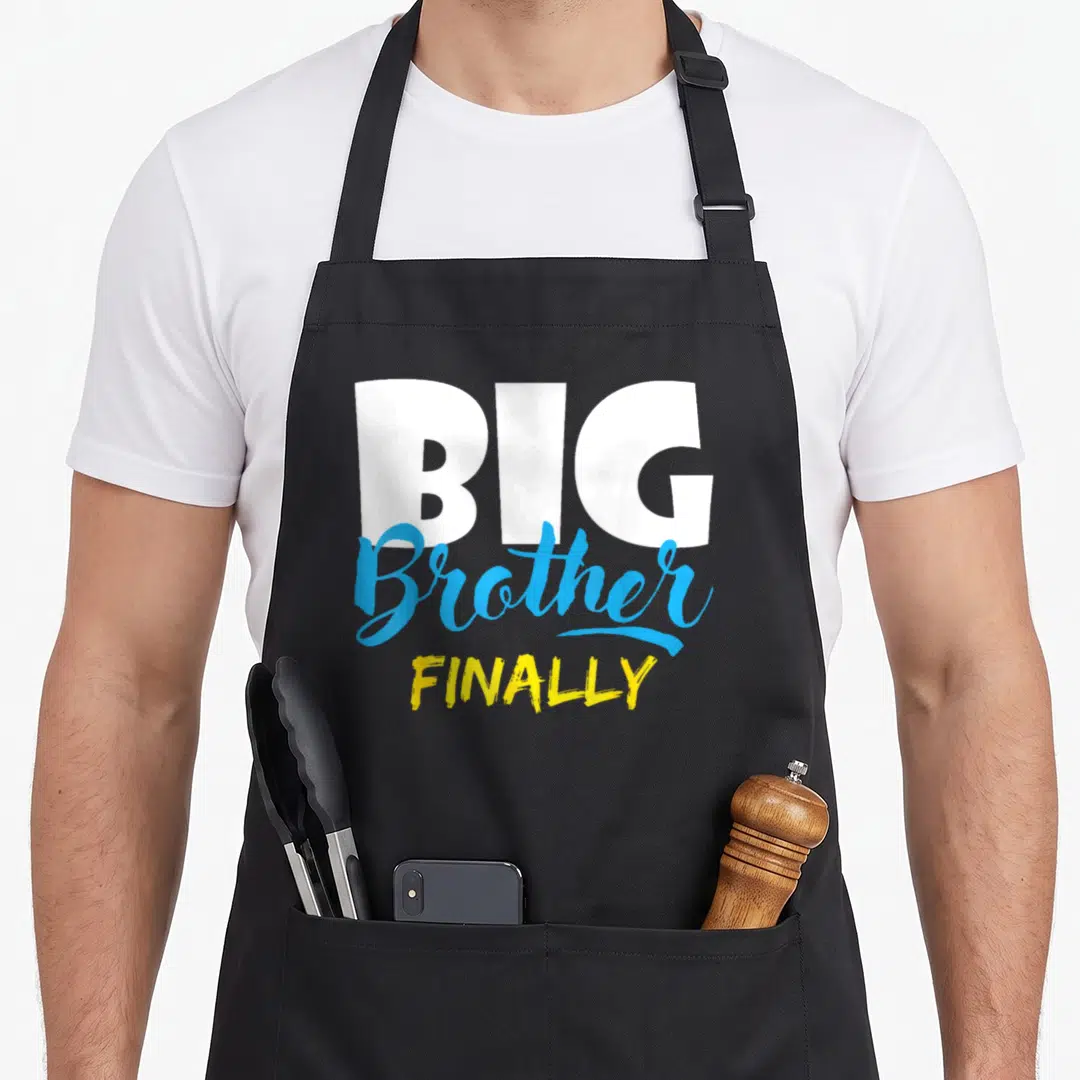 Finally brother apron - BIG Brother FINALLY text in white blue and yellow stacked typography — shown on a black cotton canvas apron against a white background