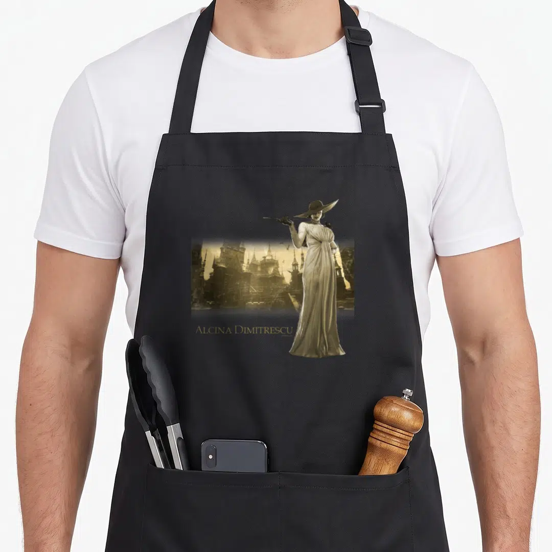 Village resident apron - Woman in gown standing right of sepia castle with gold Alcina Dimitrescu text below — shown on a black cotton canvas apron against a white background