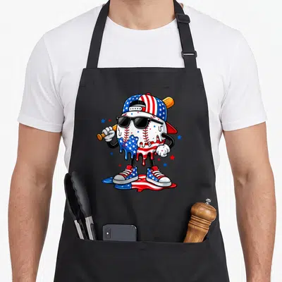4th drip apron - Cartoon baseball character wearing sunglasses and cap standing in melting flag colors surrounded — shown on a black cotton canvas apron against a white background