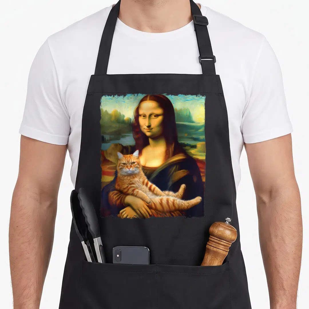 Mona cat holding apron - Woman holding orange tabby cat against swirling landscape in blue orange brown green — shown on a black cotton canvas apron against a white background