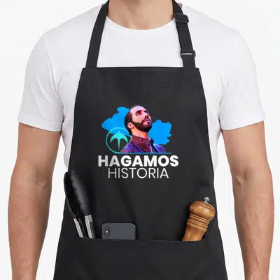 Hagamo el salvador apron - Man portrait blue map shape bird symbol Hagamos Historia white text — shown on a black cotton canvas apron against a white background