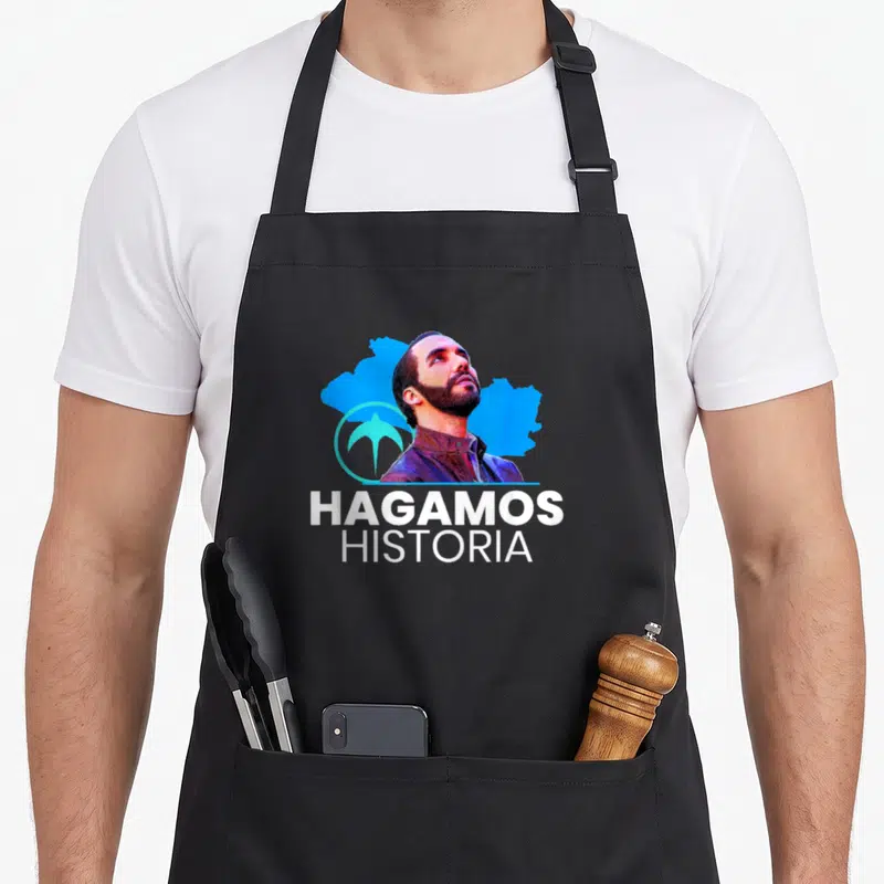 Hagamo el salvador apron - Man portrait blue map shape bird symbol Hagamos Historia white text — shown on a black cotton canvas apron against a white background