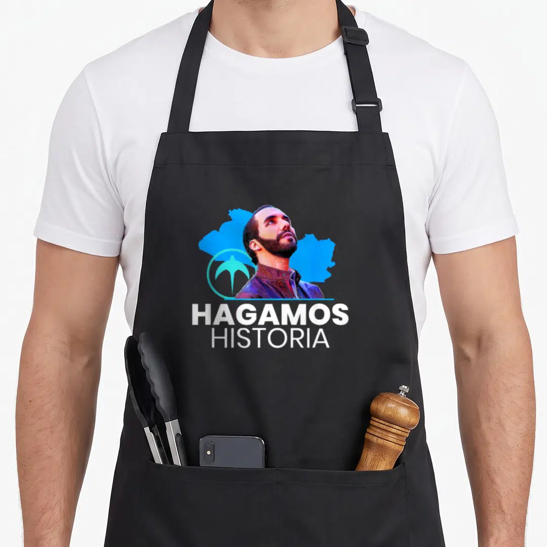 Hagamo el salvador apron - Man portrait blue map shape bird symbol Hagamos Historia white text — shown on a black cotton canvas apron against a white background