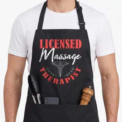 Body massage therapy apron - Distressed red and white text reading LICENSED Massage THERAPIST with a white caduceus — shown on a black cotton canvas apron against a white background