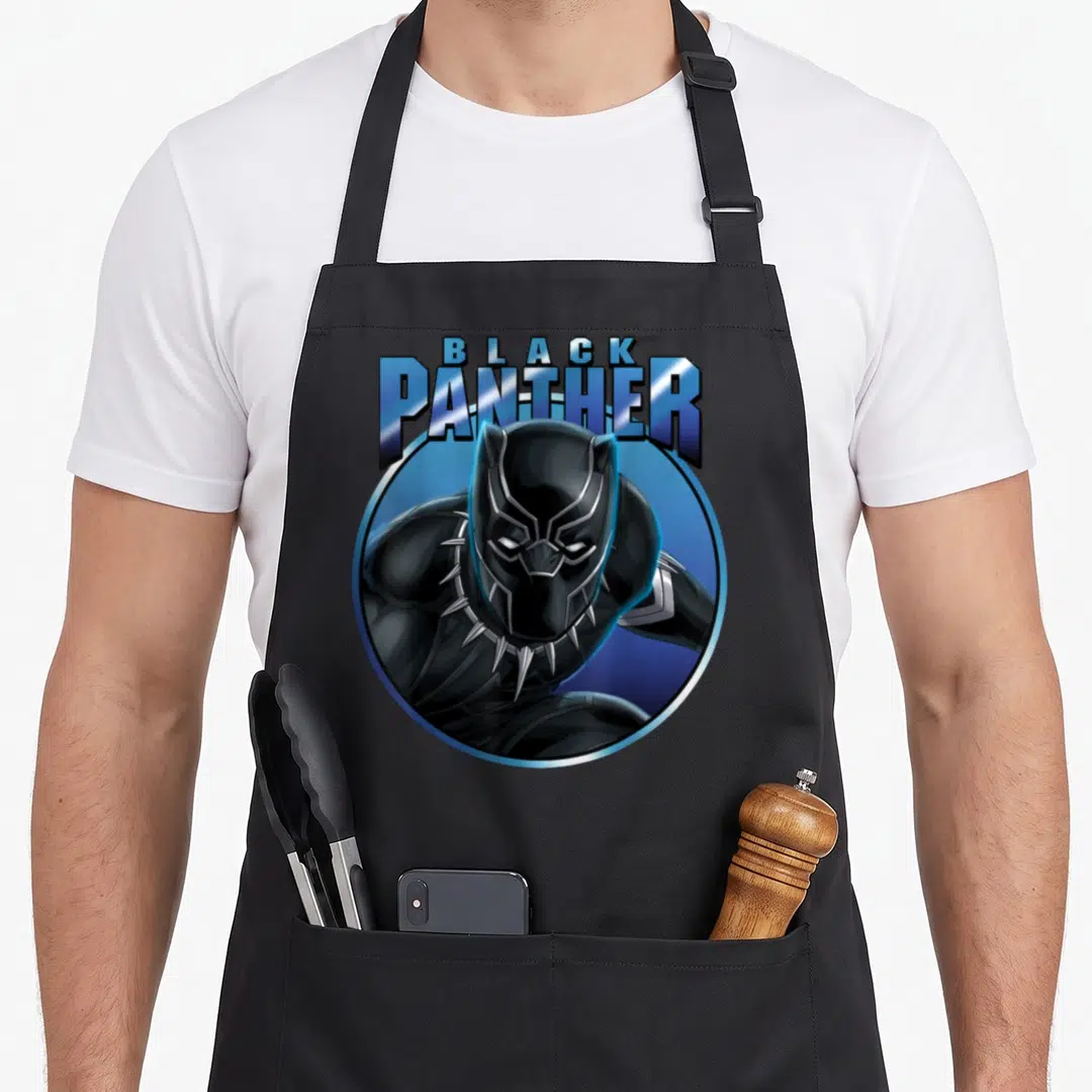 Circle panther apron - Cartoon Black Panther in blue silver circle with bold lettering — shown on a black cotton canvas apron against a white background