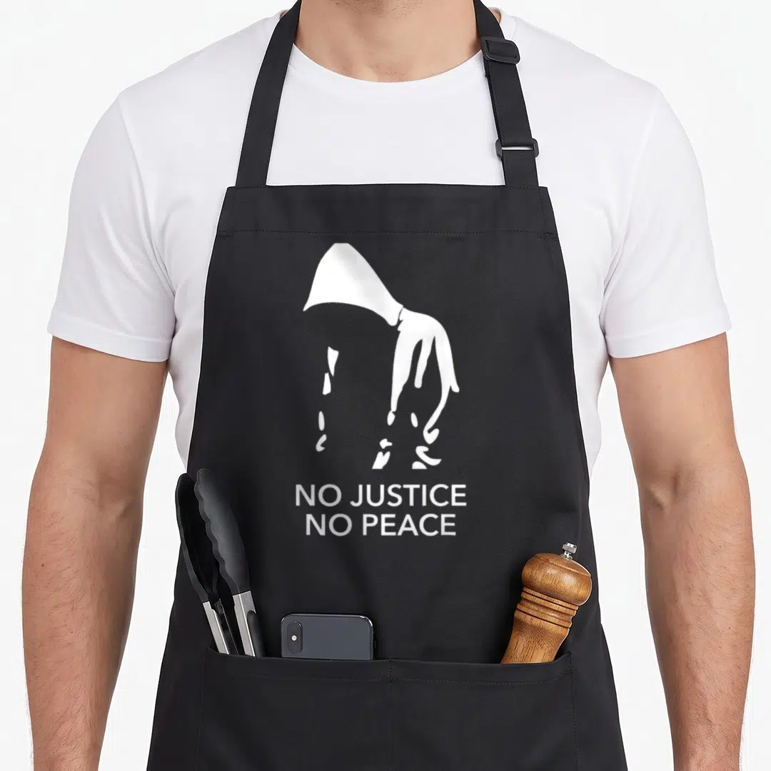Live justice of the peace apron - White hooded silhouette above white text reading NO JUSTICE NO PEACE — shown on a black cotton canvas apron against a white background