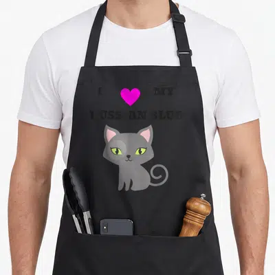 Blue cat russian aprons - Grey cartoon cat with pink ears and green eyes under I MY RUSSIAN BLUE text — shown on a black cotton canvas apron against a white background