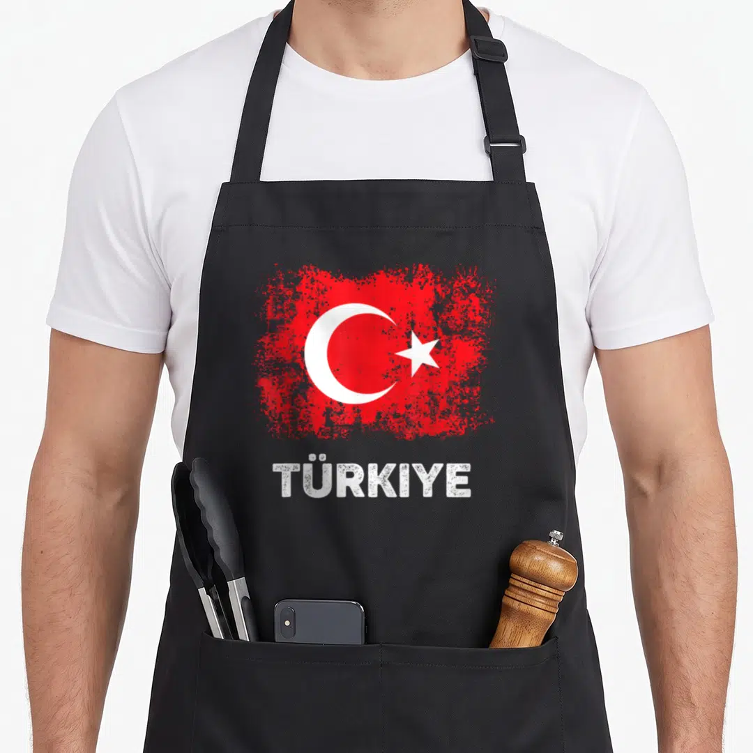 Patriot turkey apron - Distressed red flag with white crescent star and TÜRKIYE text below — shown on a black cotton canvas apron against a white background