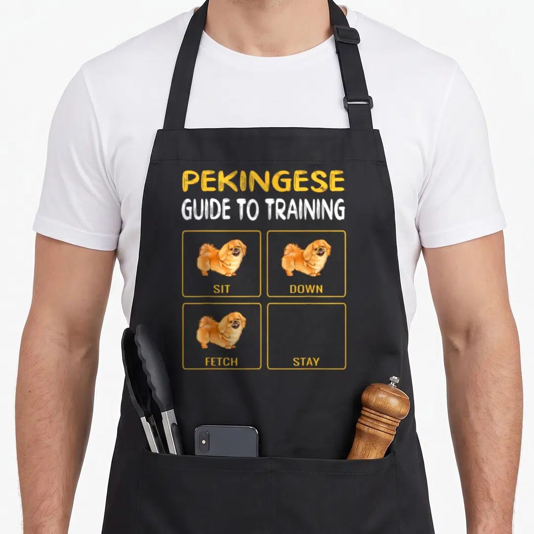 Pekingese dog training apron - Pekingese dog cartoon with sit down fetch images and empty stay box — shown on a black cotton canvas apron against a white background