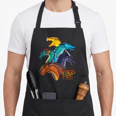 Wing fire dragon apron - Five dragon heads stacked vertically with Wings of Fire logo in stylized font — shown on a black cotton canvas apron against a white background