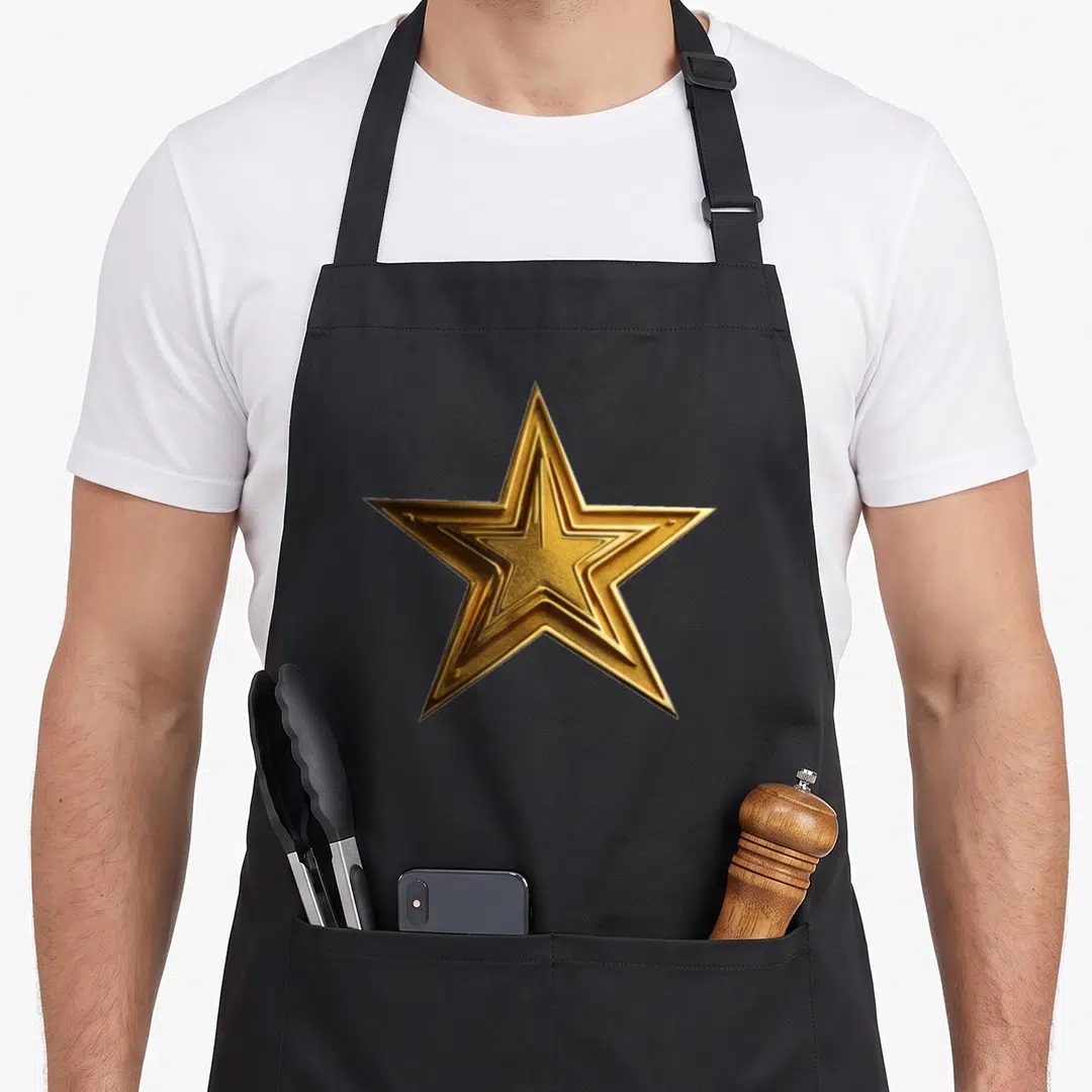 Rock special aprons - Single 3D gold star with realistic metallic texture centered on grey background — shown on a black cotton canvas apron against a white background