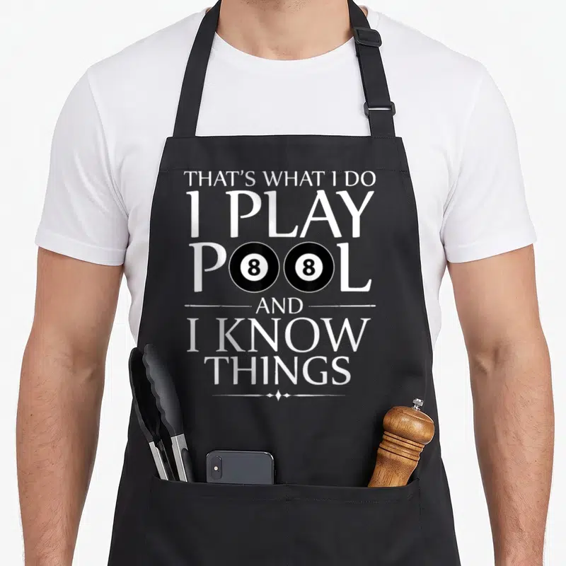 Play pool billiards apron - Stacked white text that's what i do i play pool and i know things with two 8-balls — shown on a black cotton canvas apron against a white background