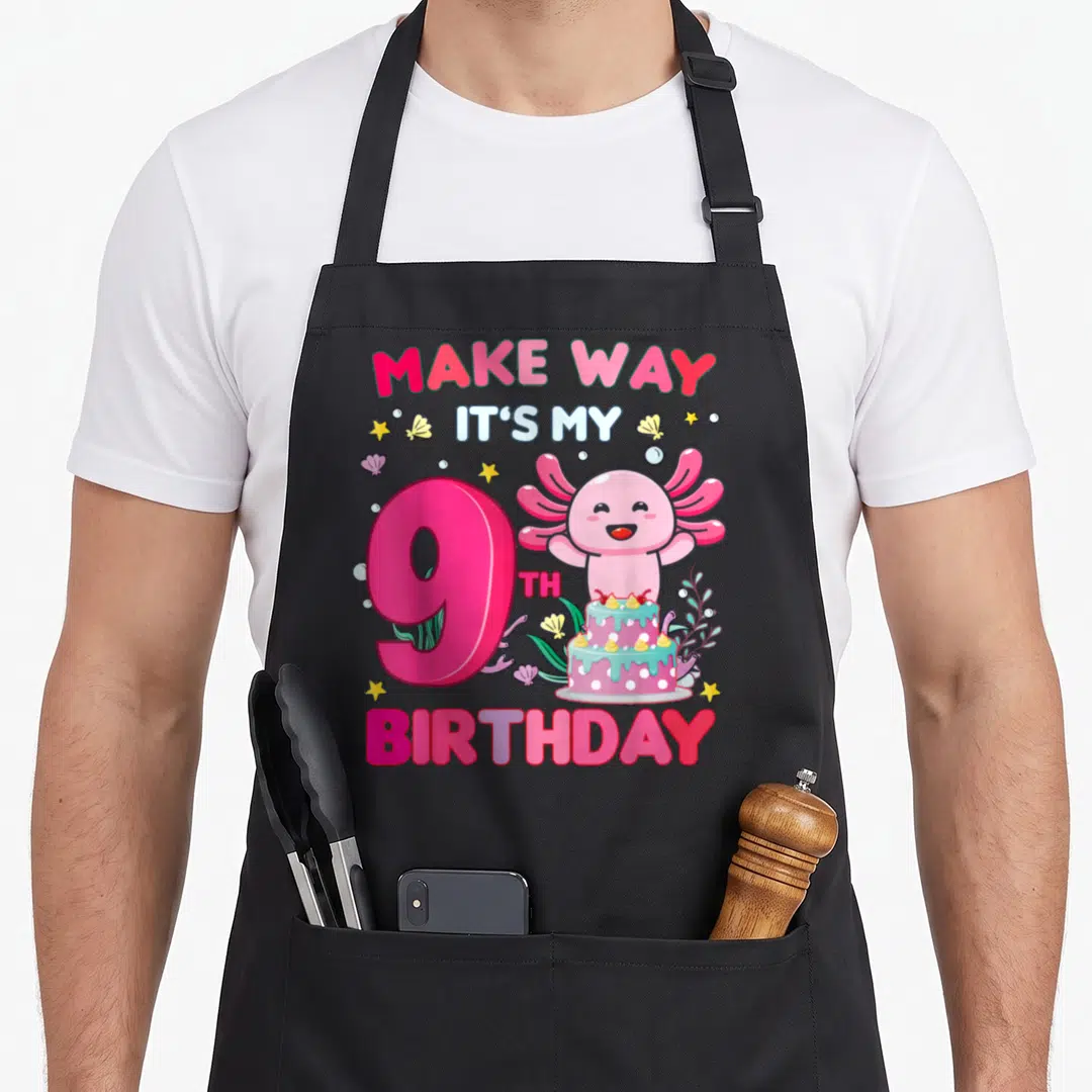 Retro axolotl birthday apron - Pink axolotl number 9 cake cartoon withMAKE WAY IT'S MY 9TH BIRTHDAY text — shown on a black cotton canvas apron against a white background