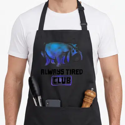 Alway eeyore apron - Blue cartoon donkey with stitched tail above black text ALWAYS TIRED CLUB in purple box — shown on a black cotton canvas apron against a white background