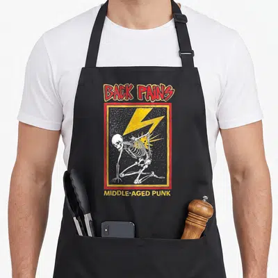 Pain punk apron - Distressed skeleton struck by yellow lightning with Back Pains text — shown on a black cotton canvas apron against a white background