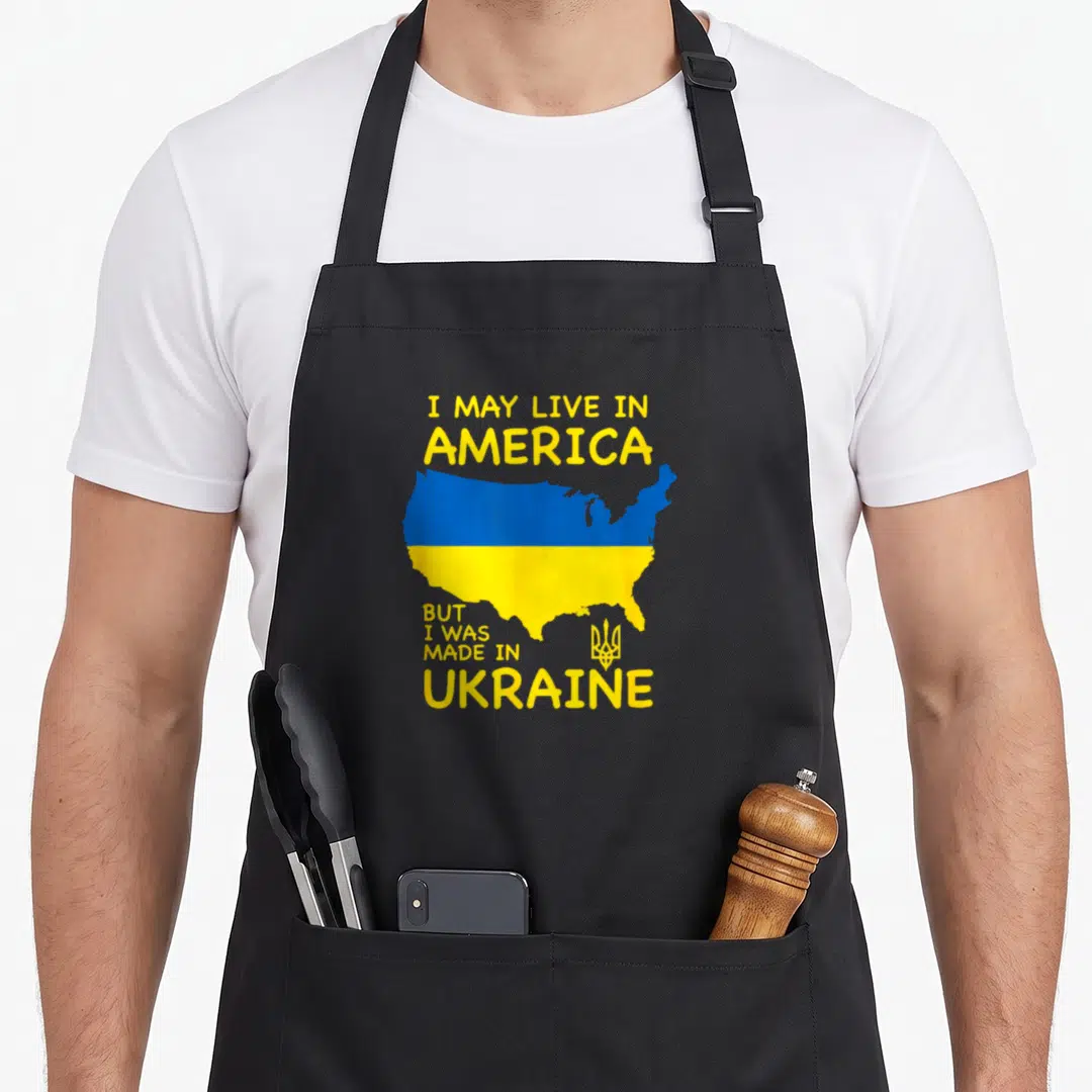 Map american flag apron - USA map filled with blue and yellow bands with text about being made in Ukraine — shown on a black cotton canvas apron against a white background