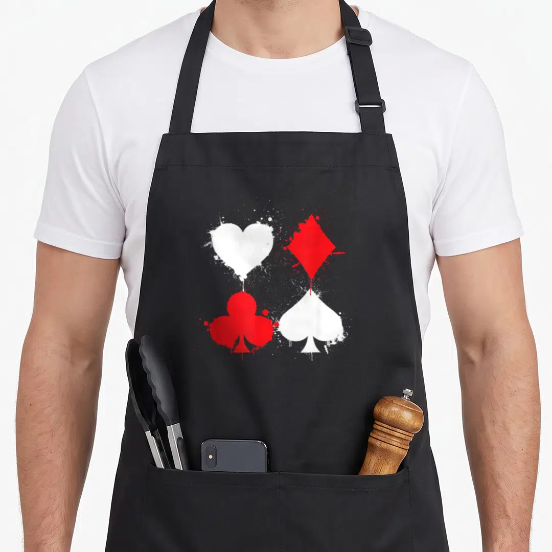 Playing poker apron - Four distressed playing card suits in red and white with paint splatter effects — shown on a black cotton canvas apron against a white background