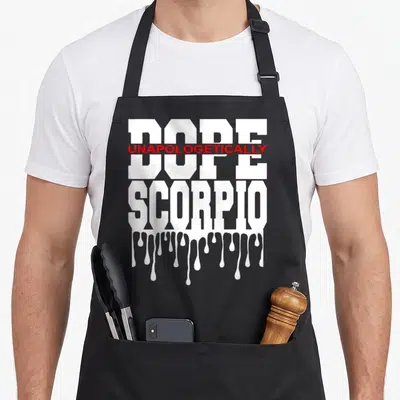Scorpio king apron - White and red typography reading Dope Unapologetically Scorpio with dripping paint effect — shown on a black cotton canvas apron against a white background