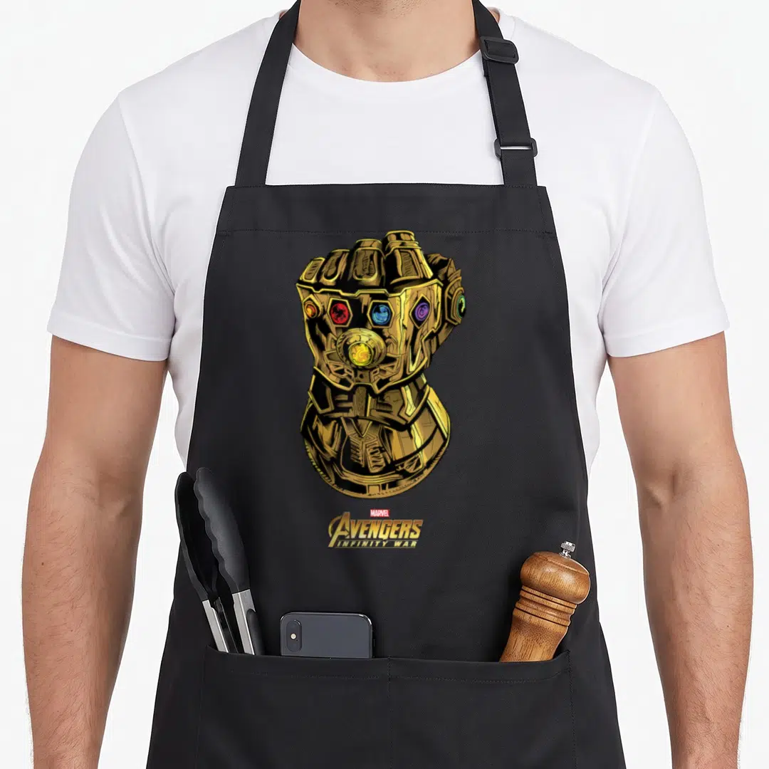 Gauntlet infinity apron - Gold Infinity Gauntlet with red gems and stacked Marvel Avengers Infinity War logo text — shown on a black cotton canvas apron against a white background