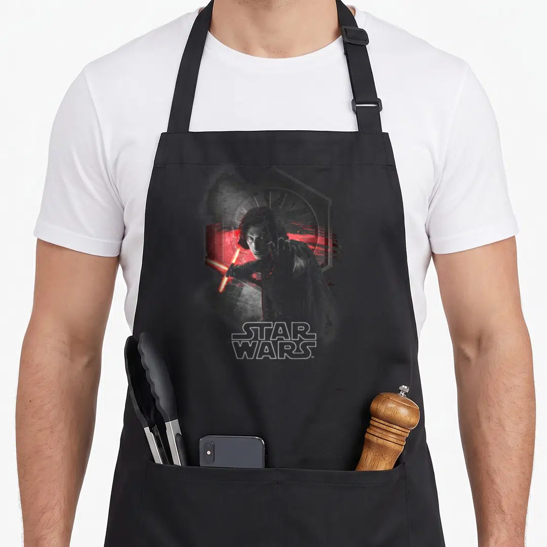 Wont novelty apron - Realistic man with red lightsaber in front of grey hexagon and STAR WARS text — shown on a black cotton canvas apron against a white background