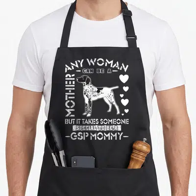 Shorthair gsp pointer apron - Distressed GSP dog illustration with hearts and Arched text reading Any Woman Can Be — shown on a black cotton canvas apron against a white background