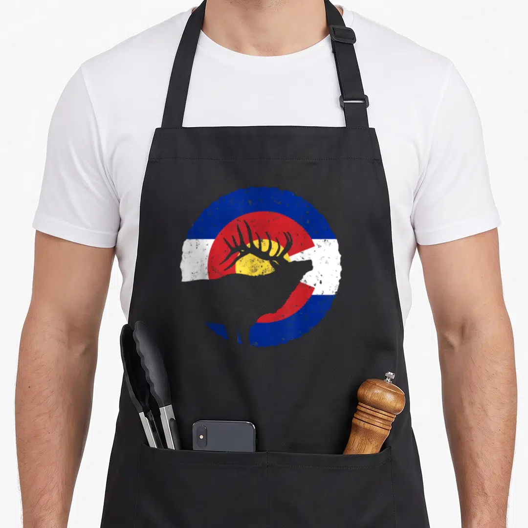 Colorado hunter apron - Grey elk silhouette over distressed circular blue red white and yellow flag design — shown on a black cotton canvas apron against a white background