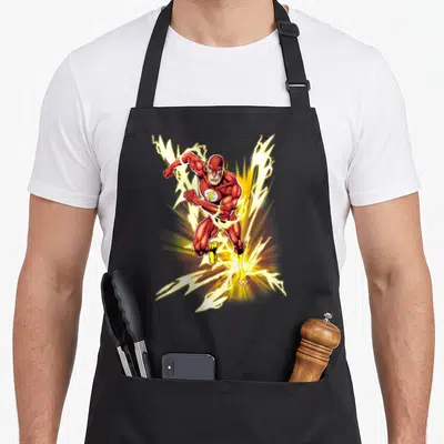 Flash speed apron - The Flash running forward surrounded by yellow lightning bolts in red and white cartoon art — shown on a black cotton canvas apron against a white background