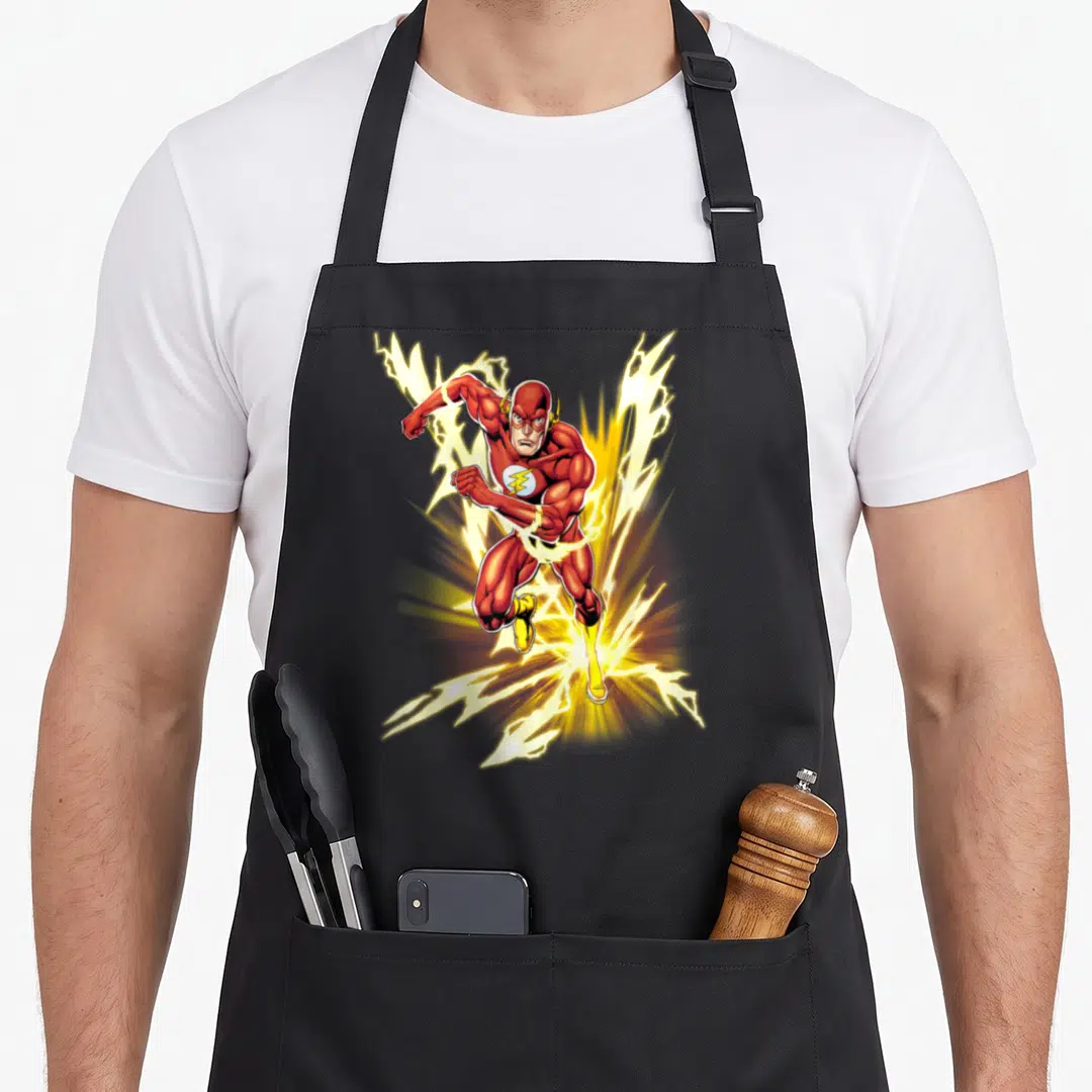 Flash speed apron - The Flash running forward surrounded by yellow lightning bolts in red and white cartoon art — shown on a black cotton canvas apron against a white background