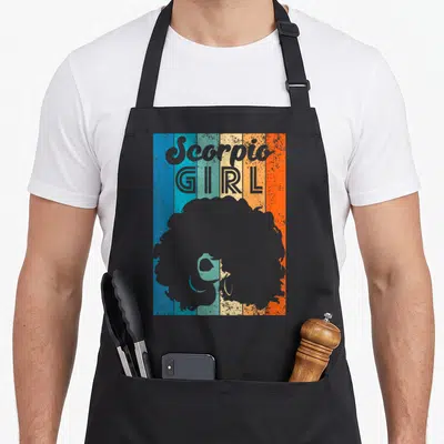 October november scorpio birthday apron - Scorpio GIRL text over woman afro silhouette on five colored vertical stripes — shown on a black cotton canvas apron against a white background