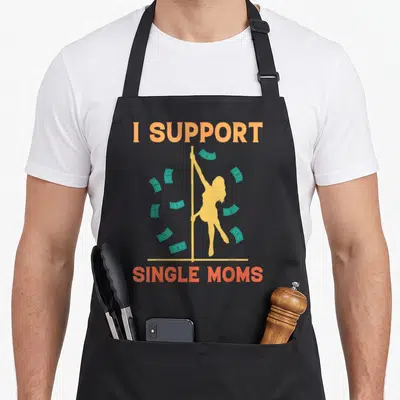 Rude strip offensive aprons - I SUPPORT SINGLE MOMS text with yellow pole dancer silhouette and teal cash bills — shown on a black cotton canvas apron against a white background