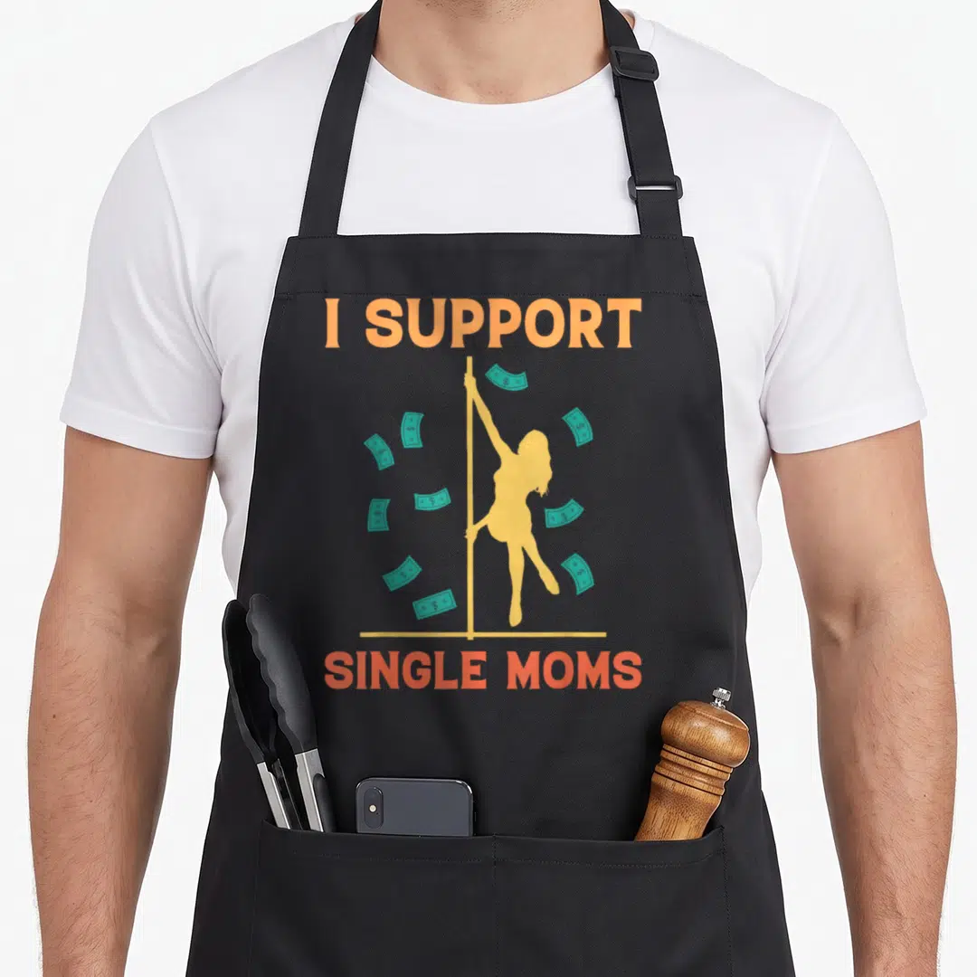 Rude strip offensive aprons - I SUPPORT SINGLE MOMS text with yellow pole dancer silhouette and teal cash bills — shown on a black cotton canvas apron against a white background