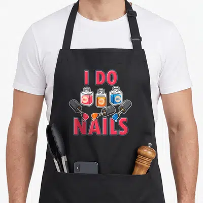 Technician manicurist apron - Three nail polish bottles in red blue and orange with brushes dripping polish under I DO — shown on a black cotton canvas apron against a white background