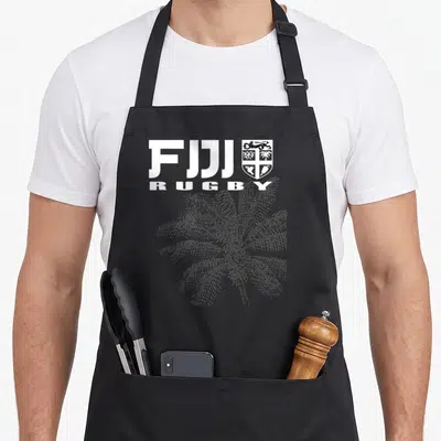 Fijian fiji apron - White FIJI RUGBY text, coat of arms, and black palm tree line art on black fabric — shown on a black cotton canvas apron against a white background