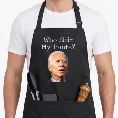 Pant wellness apron - Who Shit My Pants text above a photo of Joe Biden — shown on a black cotton canvas apron against a white background