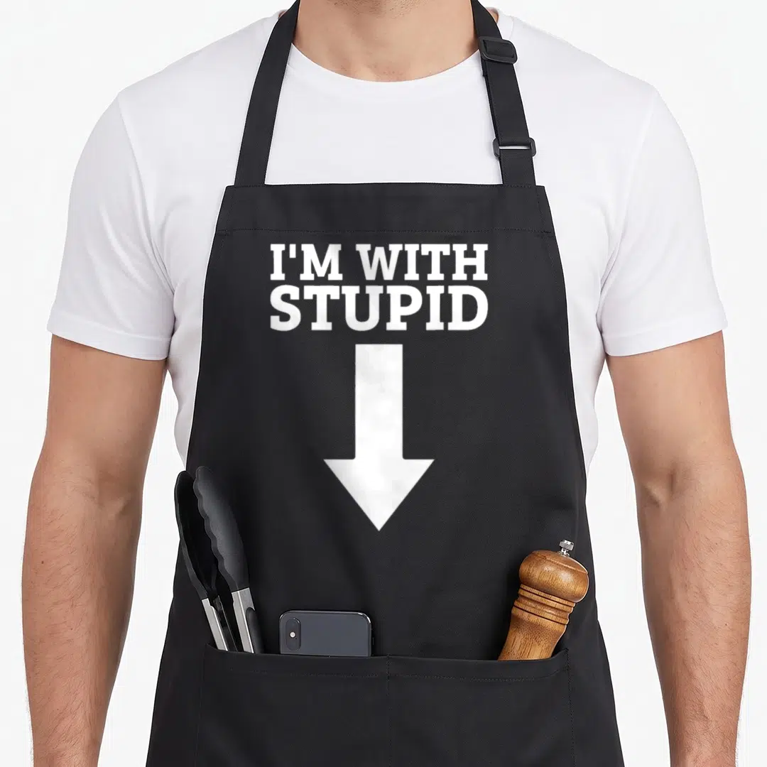 Funny arrow stupid aprons - White text reading I'M WITH STUPID above a large white downward arrow — shown on a black cotton canvas apron against a white background
