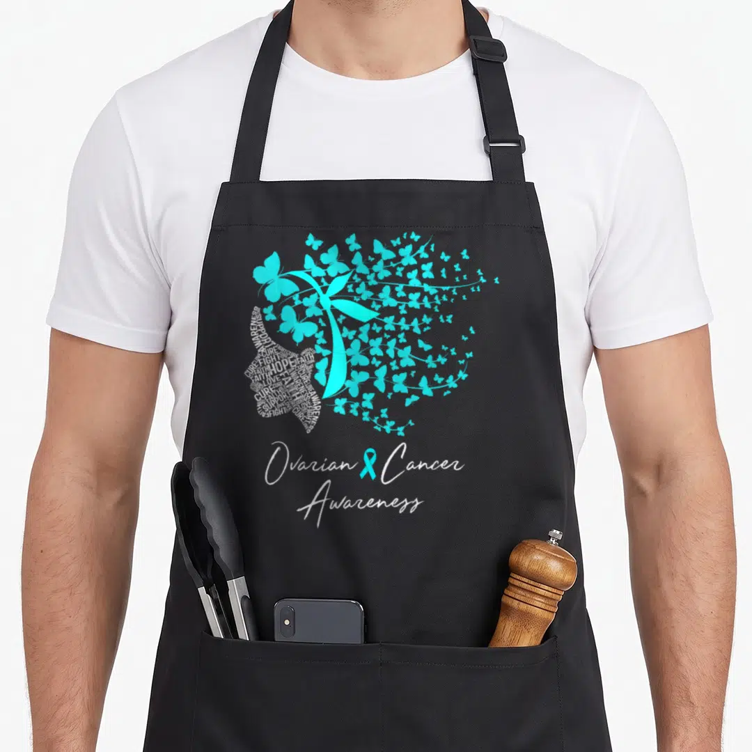 Ovarian butterfly apron - Teal ribbon surrounded by teal butterflies, one filled with white advocacy text and bottom — shown on a black cotton canvas apron against a white background