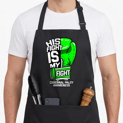 His cerebral palsy awareness apron - Green boxing glove split with text His Fight Is My Fight Cerebral Palsy Awareness — shown on a black cotton canvas apron against a white background