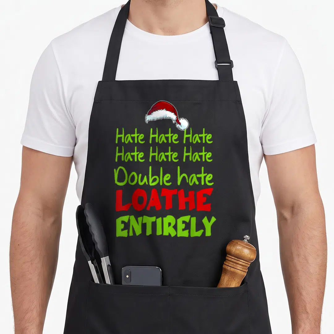 Hate double apron - Santa hat above stacked lime green and red text reading Hate Double Loathe Entirely — shown on a black cotton canvas apron against a white background