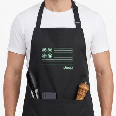 Jeep modern apron - Stylized light green flag with four stars and horizontal stripes above Jeep text — shown on a black cotton canvas apron against a white background