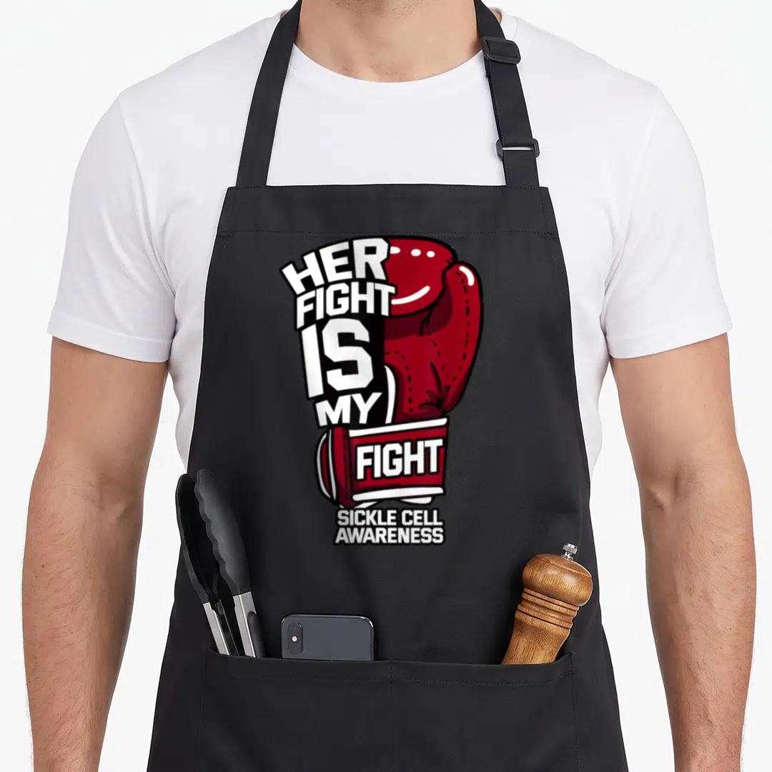 Fight sickle ribbon apron - Red boxing glove with Her Fight Is My Fight and Sickle Cell Awareness text — shown on a black cotton canvas apron against a white background