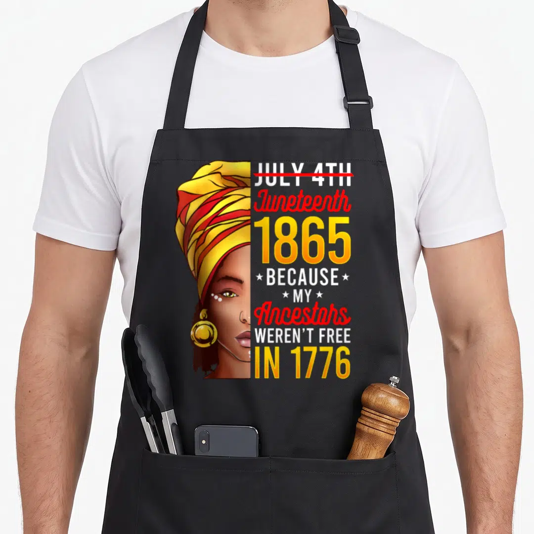 Funny juneteenth african american aprons - Woman portrait split vertically next to red line through July 4th — shown on a black cotton canvas apron against a white background