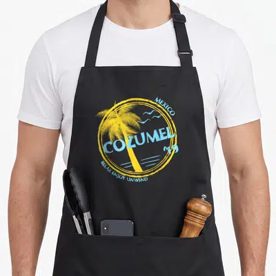 Cozumel spring aprons - Retro yellow circle with palm tree and light blue text reading Cozumel Mexico 19 — shown on a black cotton canvas apron against a white background