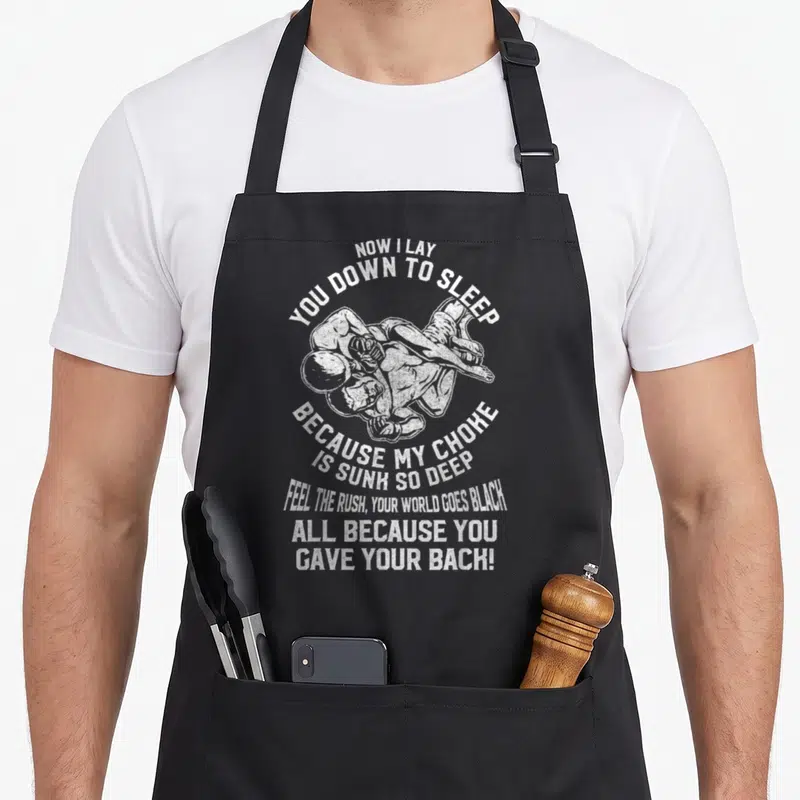 Bjj prayer apron - White distressed fighters surrounded by a sarcastic poem about a deep choke hold — shown on a black cotton canvas apron against a white background