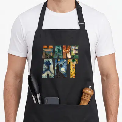 Painting artist apron - Stacked text reading MAKE ART filled with segments of famous paintings in blue, yellow, red — shown on a black cotton canvas apron against a white background