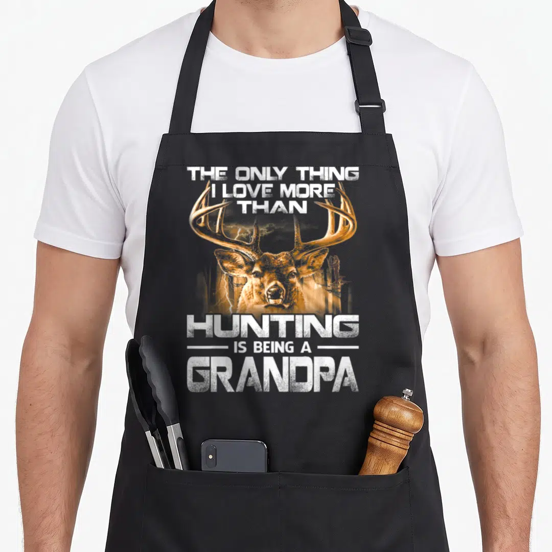 Hunting grandpa apron - Distressed deer head with white text reading THE ONLY THING I LOVE MORE THAN HUNTING IS BEING — shown on a black cotton canvas apron against a white background