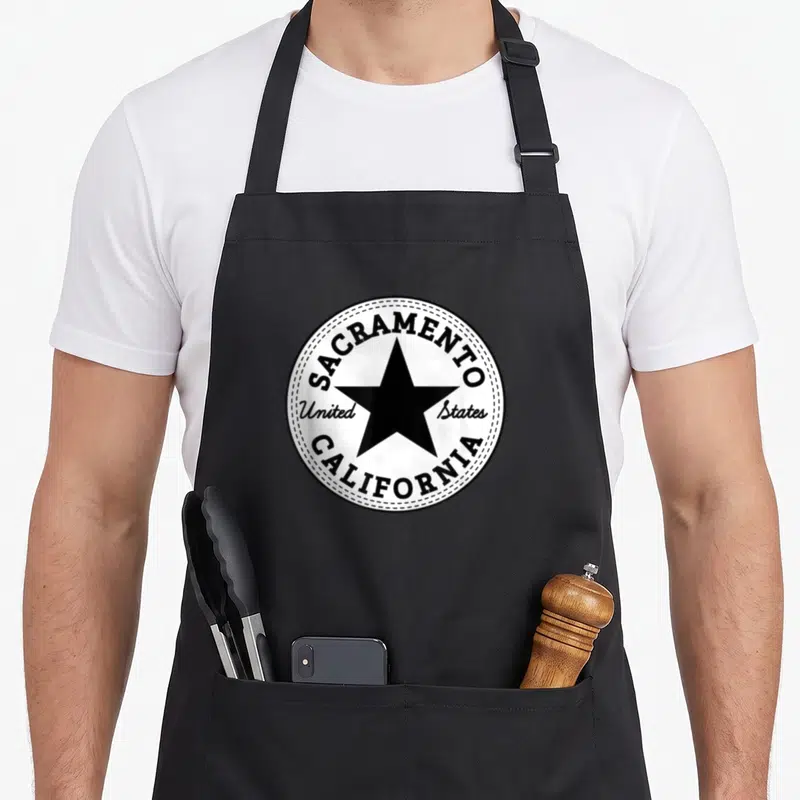 California state sacramento apron - Black star inside circle with text Sacramento California United States — shown on a black cotton canvas apron against a white background