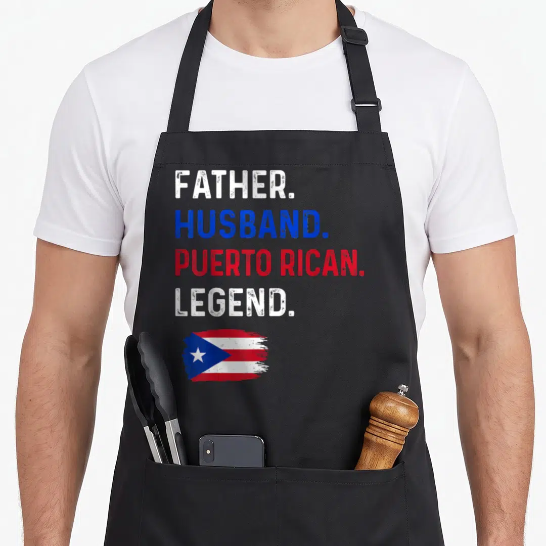 Puerto husband apron - FATHER. HUSBAND. PUERTO RICAN. LEGEND. text with distressed flag in white blue red — shown on a black cotton canvas apron against a white background
