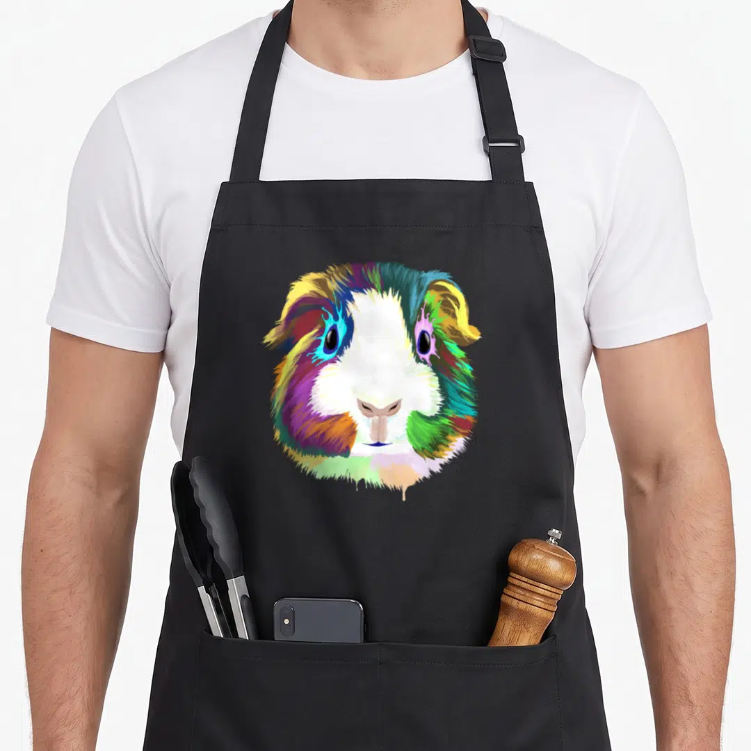 Pig i love my guinea apron - Multicolored watercolor guinea pig head in blue, green, red, yellow, purple, and white — shown on a black cotton canvas apron against a white background
