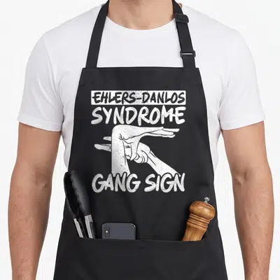 Ehler genetics apron - Distressed white hand graphic between Ehlers-Danlos Syndrome Gang Sign text — shown on a black cotton canvas apron against a white background